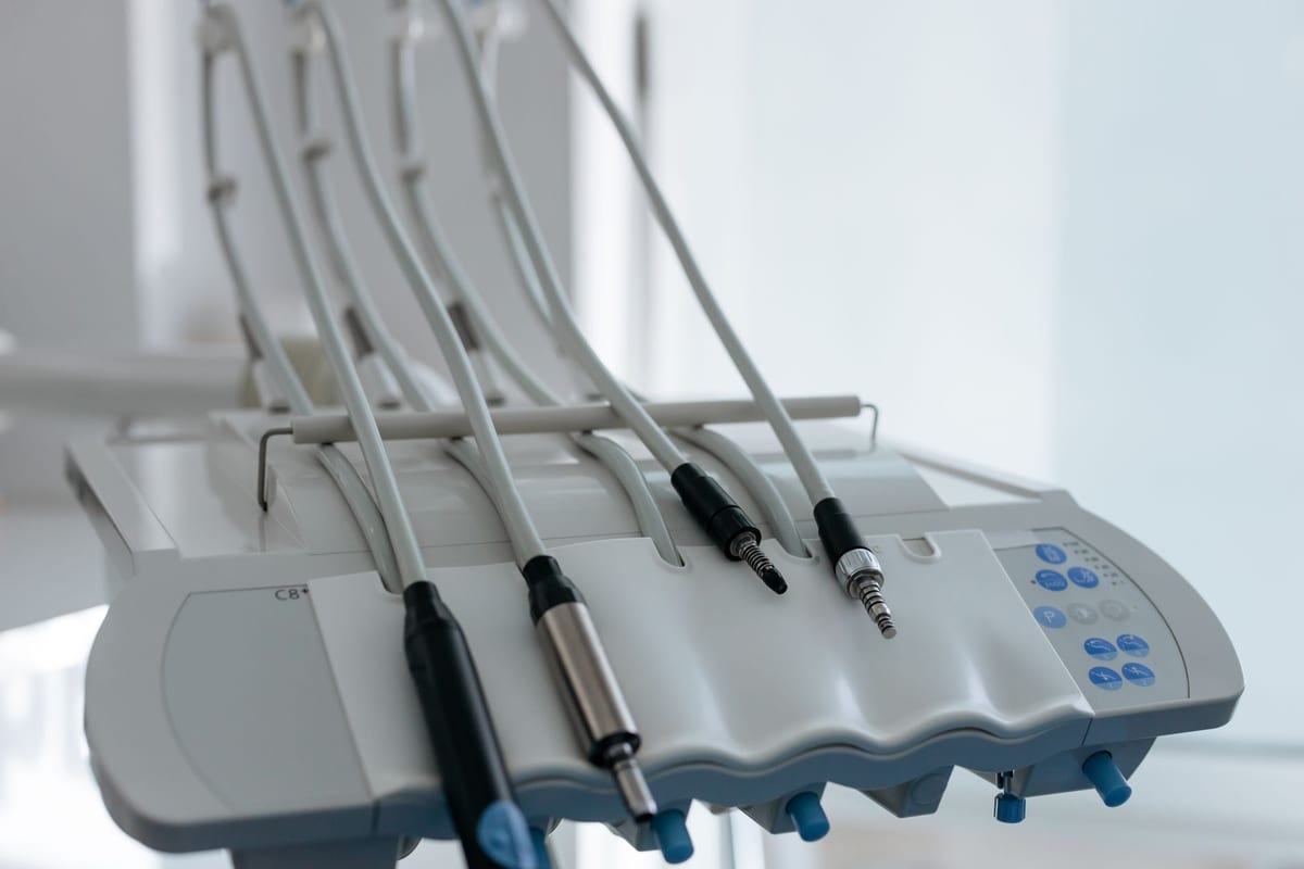 Handpiece couplings on a dental delivery unit in a white treatment room