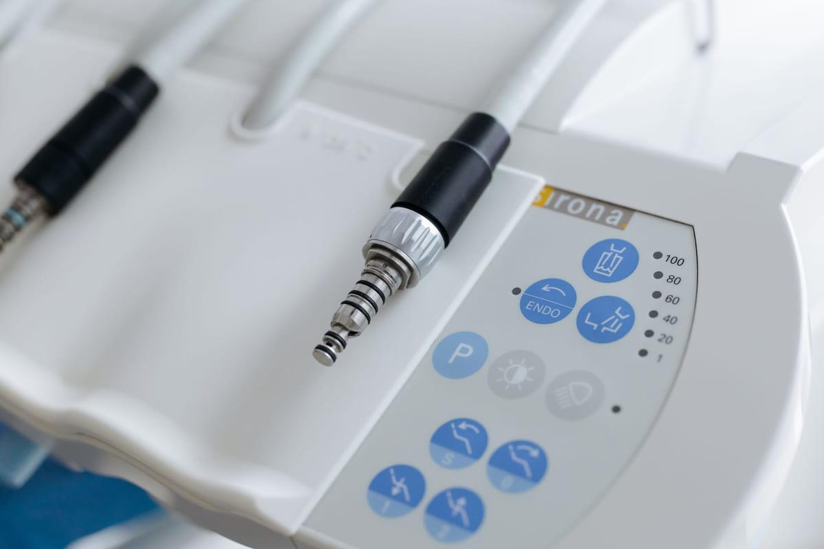 Close up of a dental unit control panel and handpiece couplings